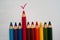 Wooden colorful crayons pencils red tick on white background