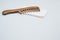 Wooden comb isolated on a white handkerchief on a gray background