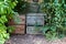 Wooden compost bin in family garden at home