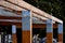 Wooden construction of the bus stop, shelter of a gazebo pergola. the roof and walls are lined with polycarbonate plexiglass glass