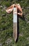 Wooden construction survey stake with faded orange ribbon