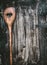 Wooden cooking spoon with heart on dark rustic background, top view. Food background for recipes
