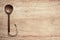 Wooden cooking  spoon vertically lying on clean wooden table top view shot,