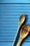 Wooden cooking spoons on a drying rack on a blue table cover