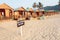 Wooden cottage and cabins of sandy beach resort with sign Dont Disturb Our Guests