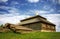 Wooden cottage on green hill