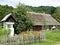 A wooden cottage and a roadside shrine, The Museum of Folk Architecture in Sanok, Poland