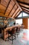 Wooden Counter bar with many brands of liquor on the shelf with moving bartender Mixologist at the hip roof restaurant