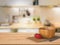 Wooden counter top with tomato and wooden bowl