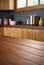 A wooden countertop in a kitchen is positioned next to a window. The countertop is clean and well-maintained, adding a