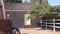 Wooden covered wagon on wheels, wild west pioneer ranch. Western farm or saloon.