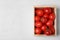 Wooden crate filled with fresh delicious tomatoes on table, top view