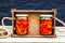 Wooden crate with glass jars with pickled red bell peppers.Preserved food concept, canned vegetables isolated in a rustic