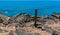 Wooden Cross Above The Rugged Volcanic Shoreline