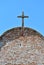 Wooden Cross against the blue sky on Roof