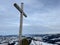 A wooden cross or Christian crucifix on top of the Swiss mountain Kronberg in the Appenzell Alps massif, UrnÃ¤sch / Urnaesch