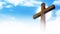 Wooden cross on clouds background