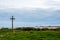 A wooden cross, on a grassy island