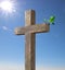 Wooden cross with an green branch