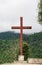 Wooden cross on lush mountain top