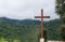 Wooden cross on lush mountain top