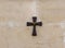 Wooden cross with number 14 - the fourteenth stop of the Way of the Cross on the wall catholic Christian Transfiguration Church