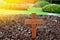 A wooden cross rose to the ground with natural background,