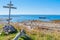 Wooden cross on shore of the White Sea at Anzersky Island. Solovky Islands, Russia