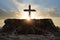 Wooden cross in sunlight in dark cave. Crucifixion and resurrection. Religion and Easter concept