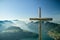 Wooden cross on viewing platform on top of Fronalpstock peak above the small village of Stoos
