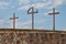 Wooden crosses silhouetted against a clear blue sky