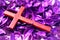 Wooden crucifix cross on dried purple flowers background in holy week