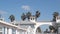 Wooden Crystal pier and white blue cottages on ocean beach, California USA.