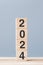 wooden cube block with 2024 text on table background. Resolution, plan, review, goal, start and New Year holiday concepts