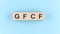 Wooden cube block with text GFCF on the blue background