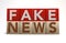 Wooden cube block on white background with word fake news. Concept. Junk news deliberate disinformation or hoaxes