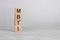 wooden cube on a concrete surface with text MBTI, copy space on right for design, gray background