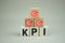 Wooden cube KPI with goals icon. The concept of evaluate performance results of the year