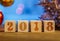 Wooden cubes 2018. Cometh the new year. Blurred background. A place for a label. With the New year.