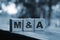 Wooden cubes with the abbreviation M and A on them. Business concept