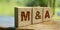 Wooden cubes with the abbreviation M and A on them. Business concept