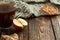 Wooden cubes with Autumn inscription on a wooden dark background with colorful maple leaves and acorn