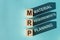 Wooden cubes building word MRP - Abbreviation of Material requirements planning on light blue background