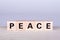 wooden cubes building the word Peace, white background