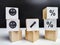 Wooden cubes in a column and a row with white signs with a smiley sign, an arrow, a percentage. The concept of