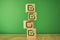 wooden cubes with the image of check marks marks on a green background