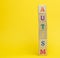 Wooden cubes with the inscription autism on a yellow background. Concept of support and encouragement for children with