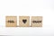 Wooden cubes with the inscription feel love enjoy on a white