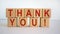 Wooden cubes with the inscription `thank you`. Beautiful white background, copy space