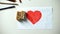 Wooden cubes with love word lying on red heart picture, true relationships